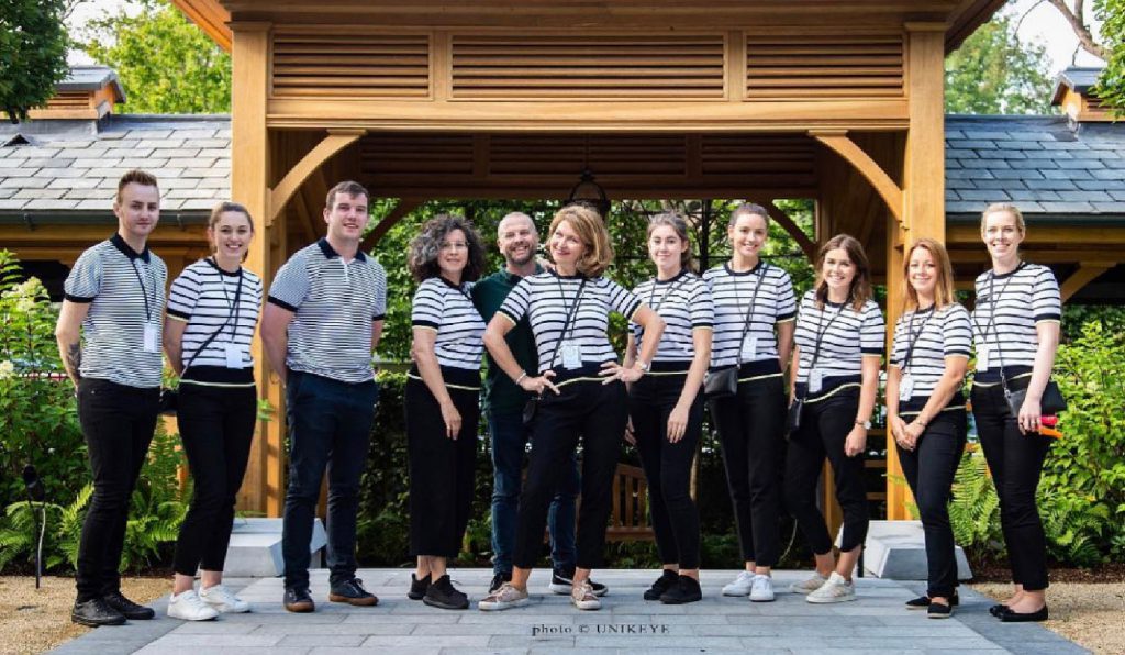 Tara Fay and her team dressed in striped tops and black pants.